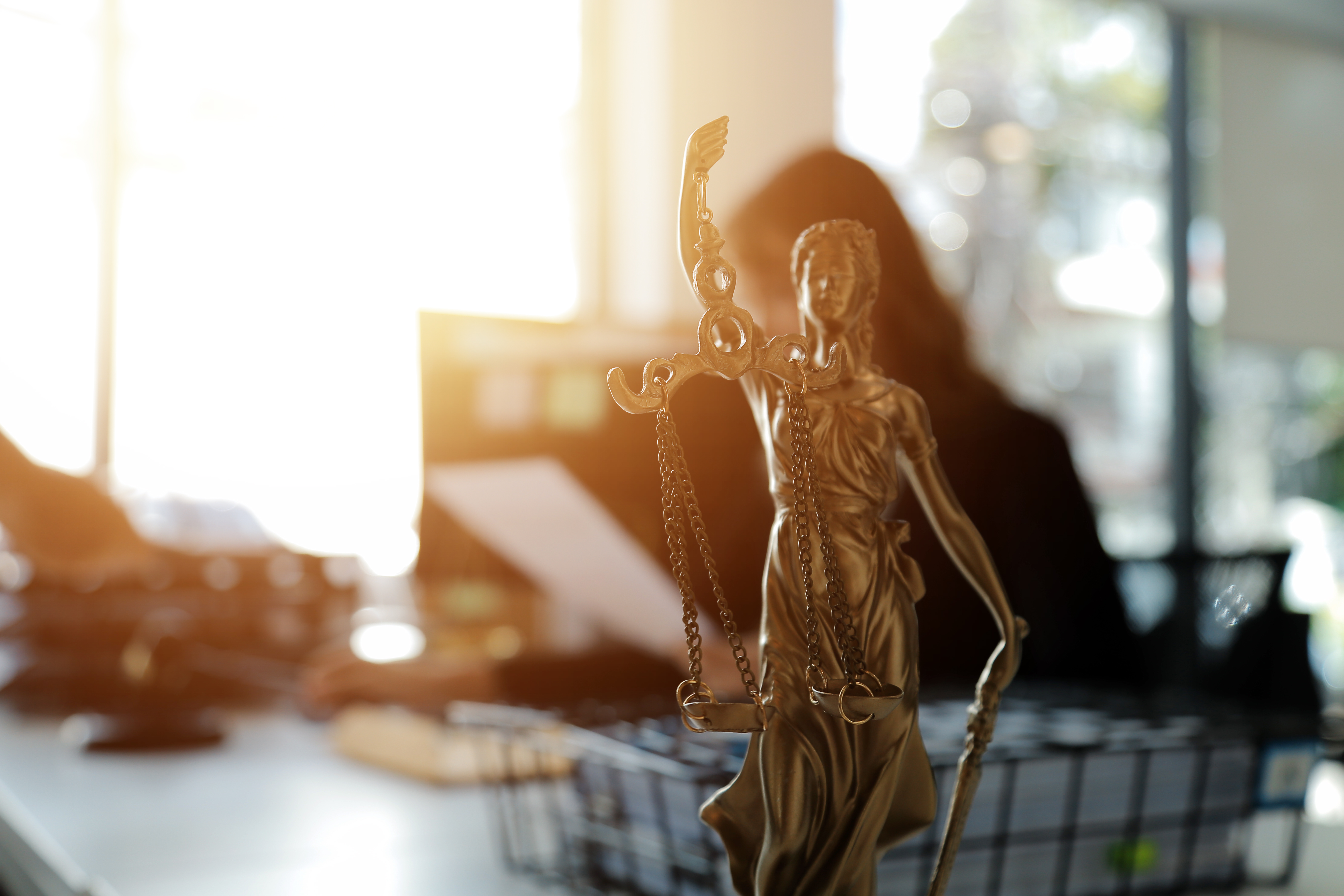 Judge gavel and legal team meeting representing criminal defense