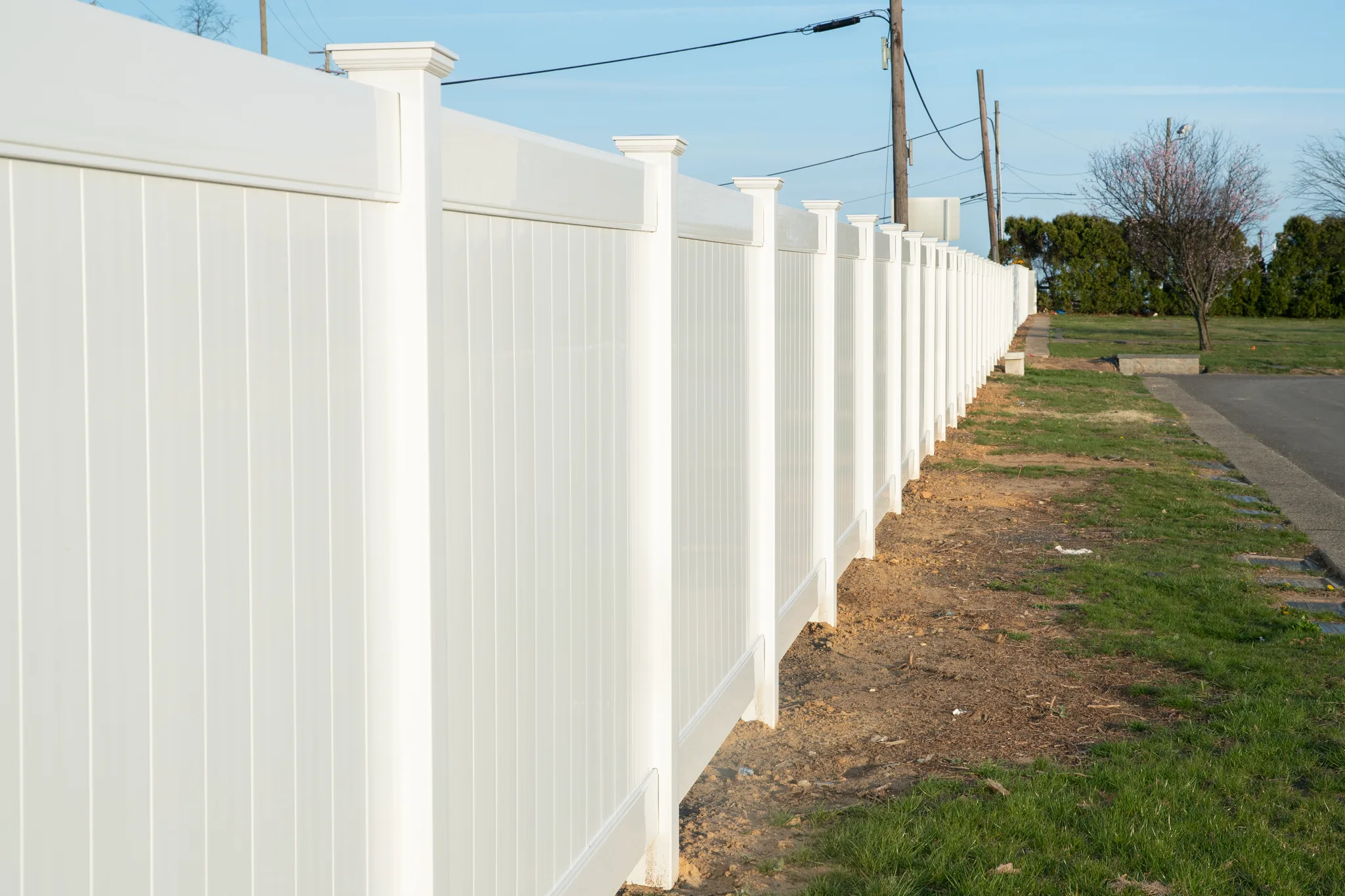 Commercial vinyl fence installed along a business property line